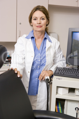 A Doctor Standing By A Computer Monitor