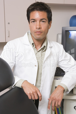 A Doctor Standing By A Computer Monitor