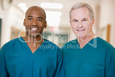 Two Orderlies Standing In A Hospital Corridor