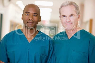 Two Orderlies Standing In A Hospital Corridor