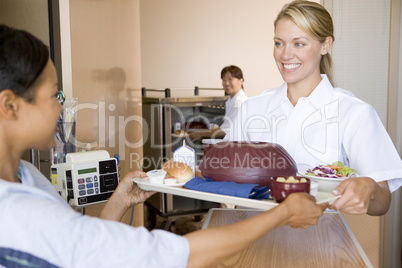 Nurse Serving A Patient A Meal In Her Bed