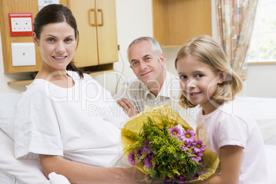 Daughter And Father Visiting Mother In Hospital