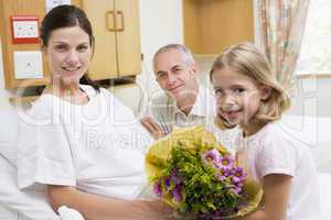 Daughter And Father Visiting Mother In Hospital