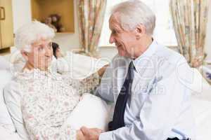 Senior Man Sitting With His Wife In Hospital