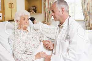 Doctor Talking With Senior Woman Patient In Hospital