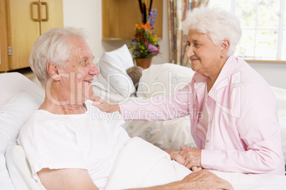 Senior Couple Sitting Together In Hospital