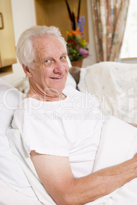 Senior Man Sitting In Hospital Bed