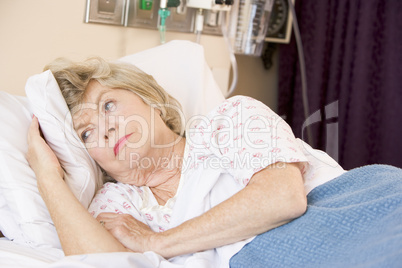 Senior Woman Lying In Hospital Bed