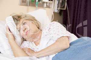 Senior Woman Lying In Hospital Bed