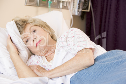 Senior Woman Lying In Hospital Bed