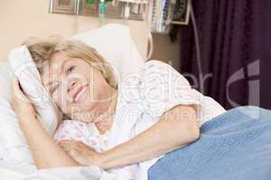 Senior Woman Lying In Hospital Bed