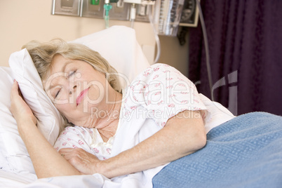 Senior Woman Sleeping In Hospital Bed