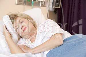 Senior Woman Sleeping In Hospital Bed