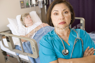 Doctor Standing With Arms Crossed In Patients Room