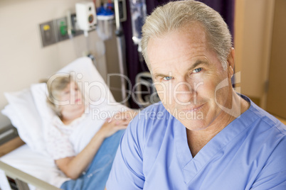 Doctor Standing In Patients Room,Looking Serious