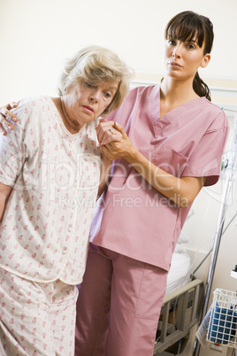 Nurse Helping Senior Woman To Walk