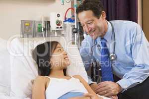 Doctor Talking To Young Girl In Hospital