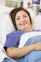 Senior Woman Smiling,Lying In Hospital Bed