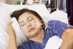 Senior Woman Asleep In Hospital Bed