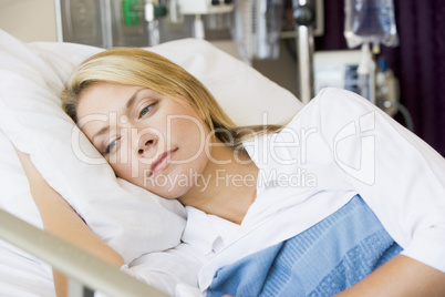 Woman Lying Down In Hospital Bed