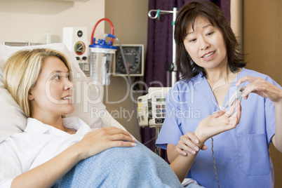 Doctor Taking Pregnant Womans Pulse