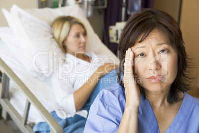 Doctor In Patients Room With Headache