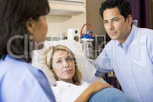 Doctor Talking To Pregnant Woman And Her Husband