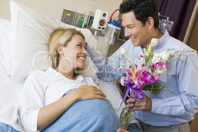 Man Giving His Pregnant Wife Flowers