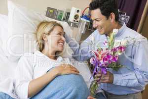 Man Giving His Pregnant Wife Flowers
