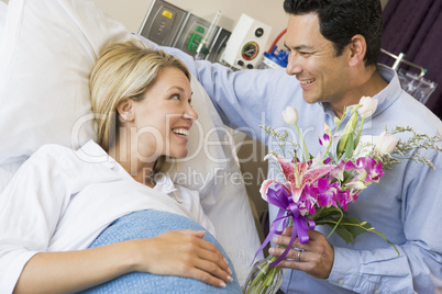 Man Giving His Pregnant Wife Flowers