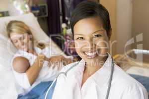 Doctor Standing In Her Patients Room,Woman Holding Baby