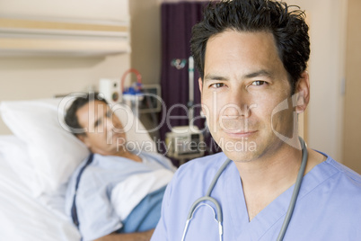 Doctor Standing In Patients Room