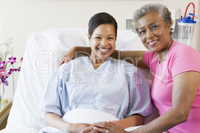 Mother And Daughter Smiling In Hospital