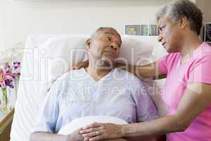 Senior Couple Looking Serious In Hospital