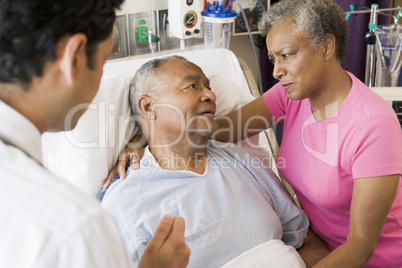 Senior Couple Talking To Doctor,Looking Worried