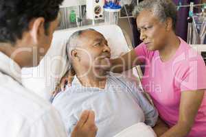 Senior Couple Talking To Doctor,Looking Worried