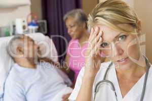 Doctor With Headache In Patients Room