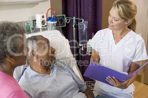 Doctor Talking To Senior Couples,Making Notes