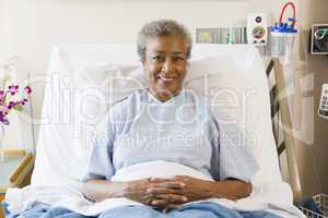 Senior Woman Sitting In Hospital Bed