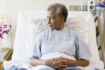 Senior Woman Sitting In Hospital Bed