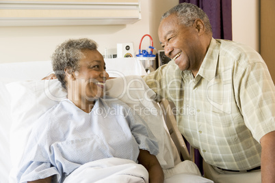 Senior Couple Smiling At Each Other In Hospital