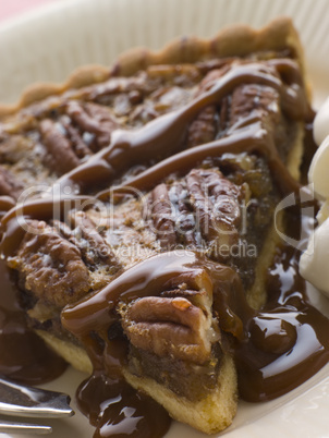 Slice Of Pecan Pie With Caramel Sauce And A Fork