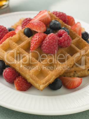 Plate Of Waffles With Berries And Maple Syrup