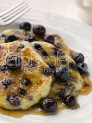 Plate Of Blueberry Pancakes With Maple Syrup