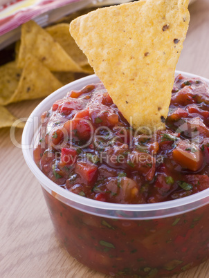 Pot Of Tomato And Coriander Salsa With A Corn Tortilla Chip