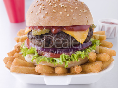Cheese Burger In A Sesame Seed Bun With Fries