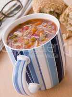 Cup Of Vegetable And Pasta Soup With A Granary Bread Roll