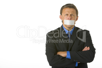 Businessman With His Arms Folded  And His Mouth Taped Shut