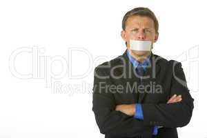 Businessman With His Arms Folded  And His Mouth Taped Shut