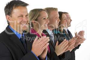Group Of Business People In A Line Smiling And Applauding